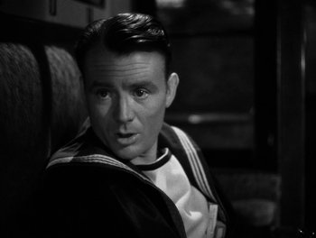 Movie still from “In Which We Serve” (1942), directed by Noël Coward – Black and white photograph of a man sitting in a chair; Close Up shot, High angle