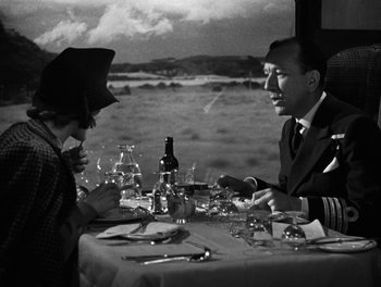 Movie still from “In Which We Serve” (1942), directed by Noël Coward – A man and a woman sitting at a dinner table; Medium shot, Over the shoulder angle