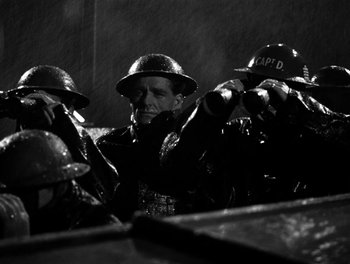 Movie still from “In Which We Serve” (1942), directed by Noël Coward – A group of men wearing helmets and leather jackets; Medium shot, Low angle