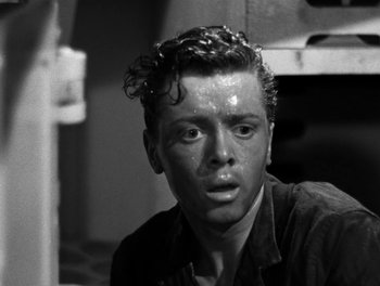 Movie still from “In Which We Serve” (1942), directed by Noël Coward – Black and white photograph of a young man with wet hair; Close Up shot, High angle