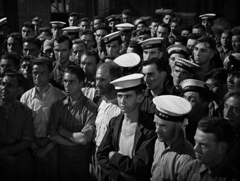 Movie still from “In Which We Serve” (1942), directed by Noël Coward – Black and white photograph of a group of men in uniform; Medium shot, High angle
