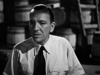 Movie still from “In Which We Serve” (1942), directed by Noël Coward – An old black and white photo of a man wearing a tie; Close Up shot, Over the shoulder angle