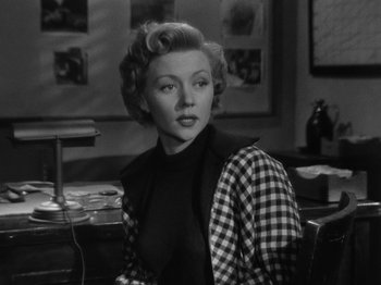 Movie still from “In a Lonely Place” (1950), directed by Nicholas Ray – An old photo of a woman sitting at a table; Medium shot, Over the shoulder angle