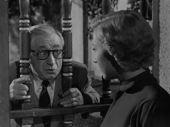 Movie still from “In a Lonely Place” (1950), directed by Nicholas Ray – An older man and a young woman looking at each other; Medium shot, Over the shoulder angle