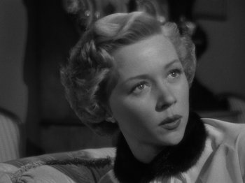 Movie still from “In a Lonely Place” (1950), directed by Nicholas Ray – A black - and - white photo of a woman in a fur collar; Close Up shot, Low angle