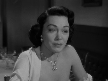 Movie still from “In a Lonely Place” (1950), directed by Nicholas Ray – An old photo of a woman in a white dress; Close Up shot, High angle