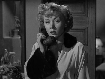 Movie still from “In a Lonely Place” (1950), directed by Nicholas Ray – A black and white photo of a woman talking on a phone; Close Up shot, Low angle