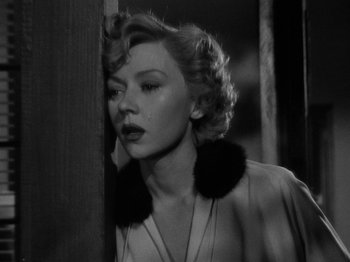 Movie still from “In a Lonely Place” (1950), directed by Nicholas Ray – A black - and - white photo of a woman in a dress; Close Up shot, Low angle