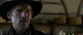 Movie still from “In a Valley of Violence” (2016), directed by Ti West – A person wearing a cowboy hat; Close Up shot, Over the shoulder angle
