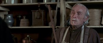 Movie still from “In a Valley of Violence” (2016), directed by Ti West – An old man with a cane in a kitchen; Close Up shot, Low angle