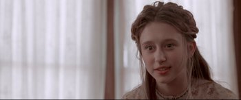 Movie still from “In a Valley of Violence” (2016), directed by Ti West – A young woman with a braid is looking at the camera; Close Up shot, Over the shoulder angle