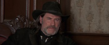 Movie still from “In a Valley of Violence” (2016), directed by Ti West – A person wearing a hat; Close Up shot, Low angle