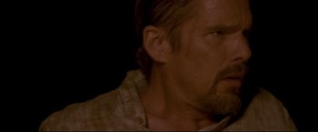 Movie still from “In a Valley of Violence” (2016), directed by Ti West – A person with a beard; Close Up shot, Over the shoulder angle