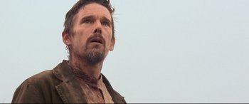 Movie still from “In a Valley of Violence” (2016), directed by Ti West – A person with a beard; Close Up shot, Low angle