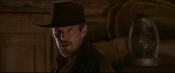 Movie still from “In a Valley of Violence” (2016), directed by Ti West – A person wearing a hat; Close Up shot, Over the shoulder angle