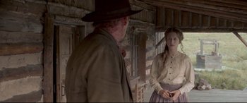 Movie still from “In a Valley of Violence” (2016), directed by Ti West – A man and a woman standing next to each other; Medium shot, Over the shoulder angle