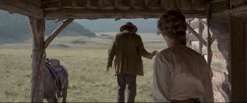 Movie still from “In a Valley of Violence” (2016), directed by Ti West – A man and a woman standing in a field; Wide shot, Over the shoulder angle