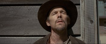 Movie still from “In a Valley of Violence” (2016), directed by Ti West – A person wearing a hat; Close Up shot, Low angle