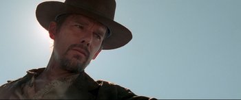 Movie still from “In a Valley of Violence” (2016), directed by Ti West – A person wearing a hat; Close Up shot, Low angle