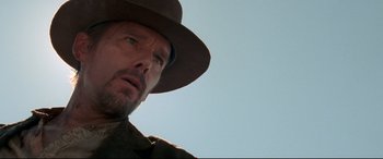 Movie still from “In a Valley of Violence” (2016), directed by Ti West – A person wearing a hat; Close Up shot, Low angle