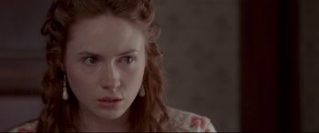 Movie still from “In a Valley of Violence” (2016), directed by Ti West – A person wearing a floral shirt; Close Up shot, Over the shoulder angle