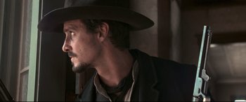 Movie still from “In a Valley of Violence” (2016), directed by Ti West – A person wearing a hat; Close Up shot, Over the shoulder angle