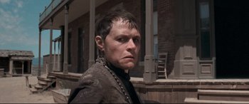 Movie still from “In a Valley of Violence” (2016), directed by Ti West – A person wearing a jacket; Close Up shot, Low angle