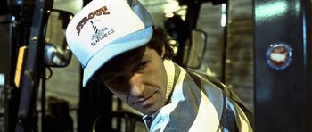 Movie still from “In the Bedroom” (2001), directed by Todd Field – A man wearing a striped shirt and a baseball cap; Close Up shot, Low angle