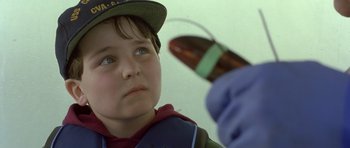 Movie still from “In the Bedroom” (2001), directed by Todd Field – A young boy looking at an electronic device; Close Up shot, Over the shoulder angle