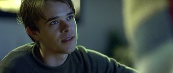 Movie still from “In the Bedroom” (2001), directed by Todd Field – A young man is looking into the distance; Close Up shot, Over the shoulder angle