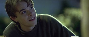 Movie still from “In the Bedroom” (2001), directed by Todd Field – A person with a smile on his face; Close Up shot, Over the shoulder angle