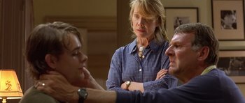 Movie still from “In the Bedroom” (2001), directed by Todd Field – Two men and a woman in a room; Close Up shot, Over the shoulder angle