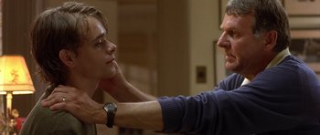 Movie still from “In the Bedroom” (2001), directed by Todd Field – A man touching another man's face with his hand; Close Up shot, Over the shoulder angle