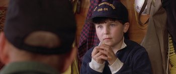 Movie still from “In the Bedroom” (2001), directed by Todd Field – A young boy wearing a baseball cap is holding his hands in his mouth; Close Up shot, Over the shoulder angle