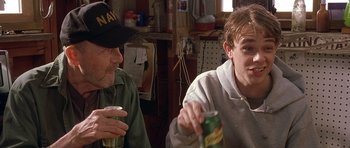 Movie still from “In the Bedroom” (2001), directed by Todd Field – Two men sitting at a table drinking beer; Medium shot, Over the shoulder angle