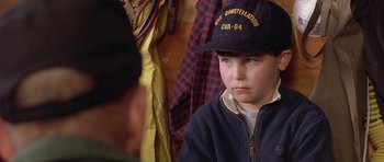 Movie still from “In the Bedroom” (2001), directed by Todd Field – A young boy wearing a hat and a jacket; Close Up shot, Over the shoulder angle