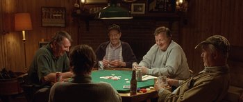 Movie still from “In the Bedroom” (2001), directed by Todd Field – A group of men sitting around a table playing cards; Medium shot, High angle