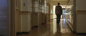 Movie still from “In the Bedroom” (2001), directed by Todd Field – A man walking down a hallway in a building; Wide shot, Low angle