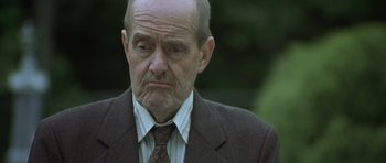 Movie still from “In the Bedroom” (2001), directed by Todd Field – An older man wearing a suit and tie; Close Up shot, Low angle