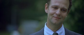 Movie still from “In the Bedroom” (2001), directed by Todd Field – A person wearing a suit and tie; Close Up shot, Over the shoulder angle