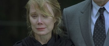Movie still from “In the Bedroom” (2001), directed by Todd Field – An older woman sitting in a chair with her eyes closed; Close Up shot, Over the shoulder angle