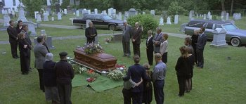 Movie still from “In the Bedroom” (2001), directed by Todd Field – A group of people gathered around a casket in a cemetery; Wide shot, High angle