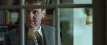 Movie still from “In the Bedroom” (2001), directed by Todd Field – A person wearing a suit and tie; Close Up shot, Over the shoulder angle