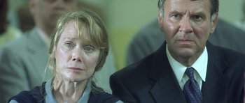 Movie still from “In the Bedroom” (2001), directed by Todd Field – A man and a woman are looking at the camera; Close Up shot, Low angle