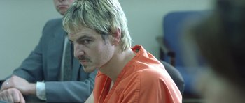 Movie still from “In the Bedroom” (2001), directed by Todd Field – A person wearing an orange shirt; Close Up shot, Low angle