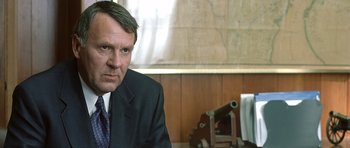 Movie still from “In the Bedroom” (2001), directed by Todd Field – A person wearing a suit and tie; Close Up shot, Over the shoulder angle