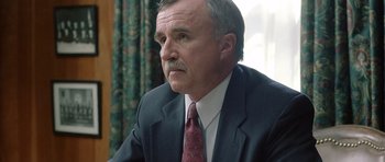 Movie still from “In the Bedroom” (2001), directed by Todd Field – An older man in a suit and tie looking off into the distance; Close Up shot, Over the shoulder angle