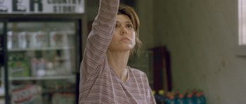 Movie still from “In the Bedroom” (2001), directed by Todd Field – A woman raises her arm in the air; Medium shot, Low angle