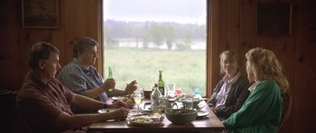 Movie still from “In the Bedroom” (2001), directed by Todd Field – Two people sitting at a table with a plate of food; Medium shot, Over the shoulder angle