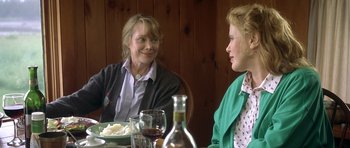 Movie still from “In the Bedroom” (2001), directed by Todd Field – Two women sitting at a table with wine glasses; Medium shot, Over the shoulder angle